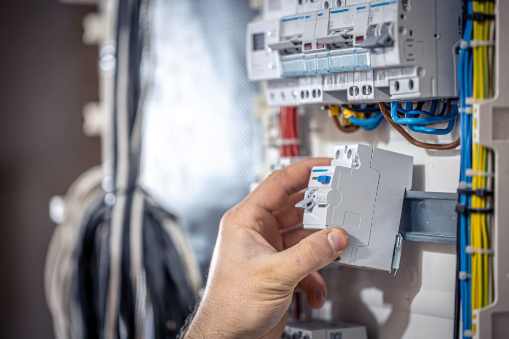 male-electrician-works-switchboard-with-electrical-connecting-cable - ASW Electrical Our Services